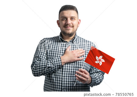 White guy holding a flag of Hong Kong and holds his hand on his heart isolated on a white background With love to Hong Kong White guy holding a flag of Hong Kong and holds his hand on his heart isolated on a white background With love to Hong Kong 78550765
