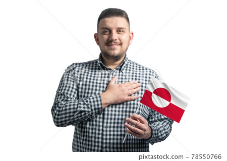 White guy holding a flag of Greenland and holds his hand on his heart isolated on a white background With love to Greenland White guy holding a flag of Greenland and holds his hand on his heart isolated on a white background With love to Greenland 78550766