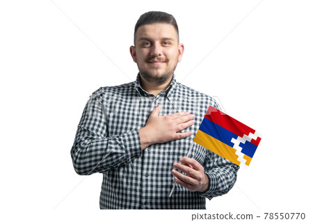White guy holding a flag of Nagorno-Karabakh Republic and holds his hand on his heart isolated on a white background With love to Nagorno-Karabakh Republic 78550770