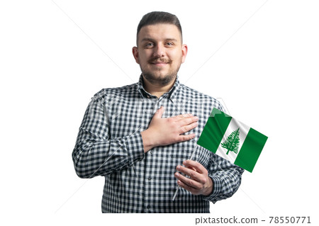 White guy holding a flag of Norfolk Island and holds his hand on his heart isolated on a white background With love to Norfolk Island White guy holding a flag of Norfolk Island and holds his hand on his heart isolated on a white background With love to Norfolk Island 78550771