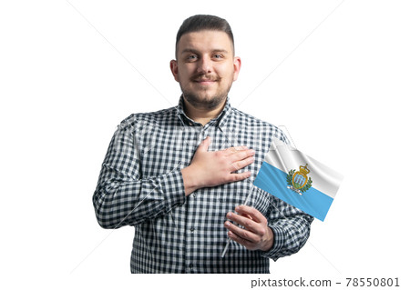 White guy holding a flag of San Marino and holds his hand on his heart isolated on a white background With love to San Marino White guy holding a flag of San Marino and holds his hand on his heart isolated on a white background With love to San Marino 78550801