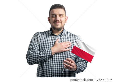 White guy holding a flag of Poland and holds his hand on his heart isolated on a white background With love to Poland 78550806