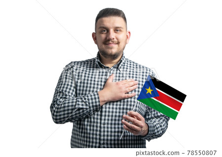 White guy holding a flag of South Sudan and holds his hand on his heart isolated on a white background With love to South Sudan 78550807