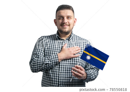 White guy holding a flag of Nauru and holds his hand on his heart isolated on a white background With love to Nauru 78550818
