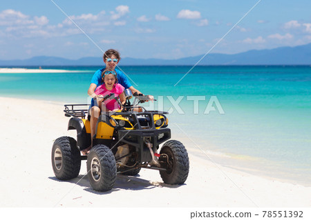 Kids on quad bike. Off road all terrain vehicle. 78551392