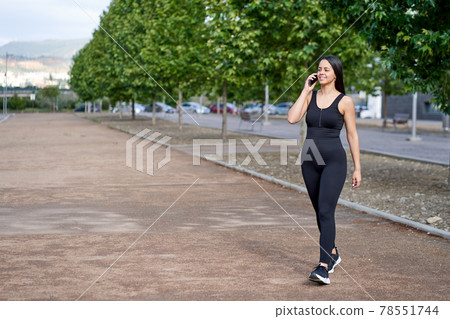 young woman with fit body talking with mobile phone young woman with fit body talking with mobile phone 78551744