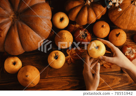A bunch of pumpkins and apples. A bunch of pumpkins and apples. 78551942