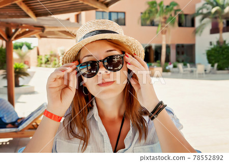 Attractive young woman adult beautiful red hair outdoors sunglasses holding hands. Beauty, fashion. 78552892