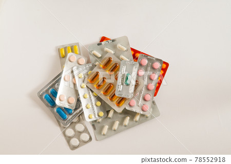 Stack of pills on a white background 78552918