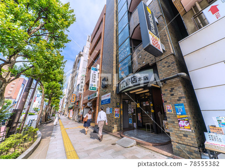 Tokyo cityscape in Japan: Kanda Jinbocho, a used bookstore district lined with shops facing north, catches the afternoon sun for a moment... There are few people around = June 11th 78555382