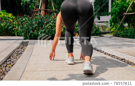 Asian sport girl doing stretching, yoga fitness and plank exercise outside. Fit young thai woman Asian sport girl doing stretching, yoga fitness and plank exercise outside. Fit young thai woman 78557611