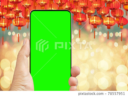 Cell phone in chinese lunar new year festival, chroma key screen. 78557951