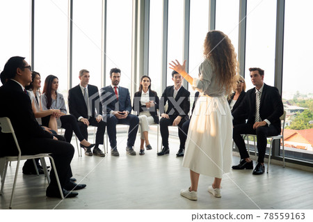 Shot of a group of businesspeople having a discussion in an office 78559163