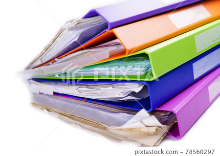 File Folder Binder stack of multi color on table in office. 78560297
