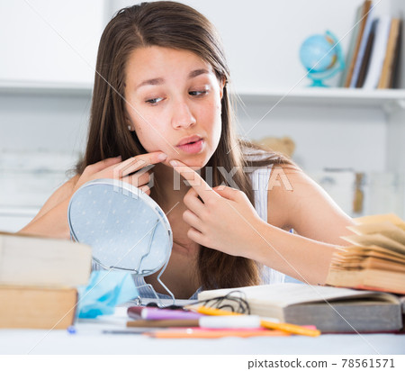 Female is squeezing out a pimple before makeup making Female is squeezing out a pimple before makeup making 78561571