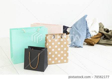 Pile of clothes and shopping bags 78562177