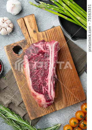Dry aged Club Steak, seasoning, on gray stone background, top view flat lay Dry aged Club Steak, seasoning, on gray stone background, top view flat lay 78563831