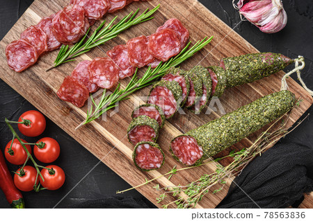 Spanish fuet salami sausage slices on black textured background Spanish fuet salami sausage slices on black textured background 78563836