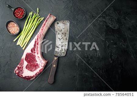 Classic fresh beef striploin steaks,Tomahawk cut, on black stone background, top view flat lay, with copy space for text Classic fresh beef striploin steaks,Tomahawk cut, on black stone background, top view flat lay, with copy space for text 78564051