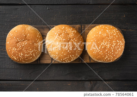 Hamburger bread Homemade Brioche Hamburger Buns, on wooden serving board, on black wooden table background, top view flat lay, with copy space for text 78564061