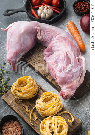 Raw fresh whole rabbit cut for stewing, on gray stone background Raw fresh whole rabbit cut for stewing, on gray stone background 78564107