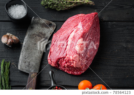 Marble beef raw with old butcher cleaver knife, on black wooden table background 78564123