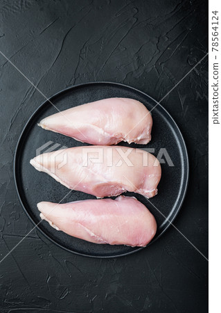 Chicken raw fillet, on black background, flat lay with space for text 78564124
