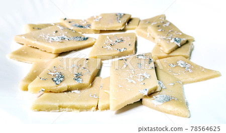 Kaju Katli is a Diamond shape Indian sweet made using cashew sugar and mava, served in a plate isolated on white background. selective focus 78564625