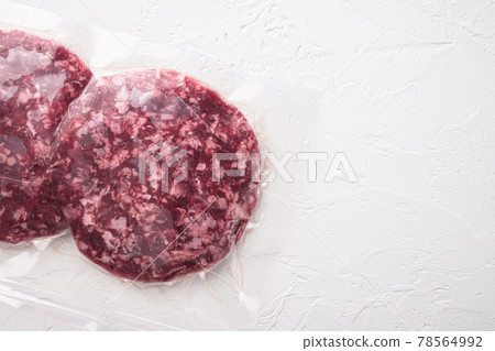 Burger meat vacuum sealed ready for sous vide cooking, on white stone background, top view flat lay, with copy space for text 78564992