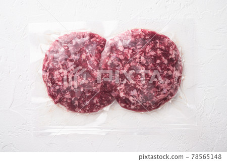 Vacuum beef cutlet sealed airtight pack, on white stone background, top view flat lay Vacuum beef cutlet sealed airtight pack, on white stone background, top view flat lay 78565148