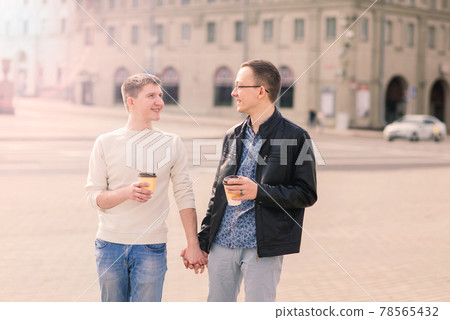 Young gay couple smiling happy and hugging at the city. Young gay couple smiling happy and hugging at the city. 78565432
