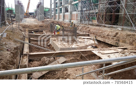 SELANGOR, MALAYSIA -JULY 14, 2016: The concrete pile cap concreted at the construction site in Selangor Malaysia. The pile cap is the part of building foundation. SELANGOR, MALAYSIA -JULY 14, 2016: The concrete pile cap concreted at the construction site in Selangor Malaysia. The pile cap is the part of building foundation. 78568415