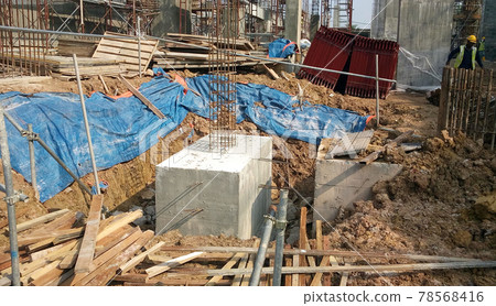 SELANGOR, MALAYSIA -JULY 14, 2016: The concrete pile cap concreted at the construction site in Selangor Malaysia. The pile cap is the part of building foundation. SELANGOR, MALAYSIA -JULY 14, 2016: The concrete pile cap concreted at the construction site in Selangor Malaysia. The pile cap is the part of building foundation. 78568416