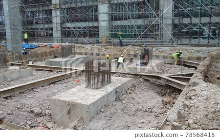 SELANGOR, MALAYSIA -JULY 14, 2016: The concrete pile cap concreted at the construction site in Selangor Malaysia. The pile cap is the part of building foundation. SELANGOR, MALAYSIA -JULY 14, 2016: The concrete pile cap concreted at the construction site in Selangor Malaysia. The pile cap is the part of building foundation. 78568418