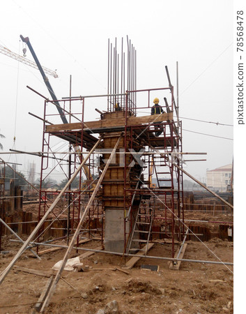 MALACCA, MALAYSIA -JULY 29, 2016: Construction workers fabricating column timber form work and reinforcement bar at the construction site in Malacca, Malaysia.  78568478