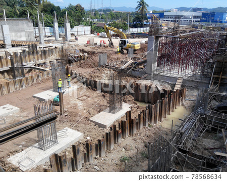 KUALA LUMPUR, MALAYSIA -MARCH 05, 2017: Temporary sheet pile cofferdam retaining wall at the construction site. It is installed to allow soil excavation and foundation work start. KUALA LUMPUR, MALAYSIA -MARCH 05, 2017: Temporary sheet pile cofferdam retaining wall at the construction site. It is installed to allow soil excavation and foundation work start. 78568634