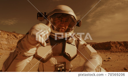 Male astronaut recording video on Mars 78569206