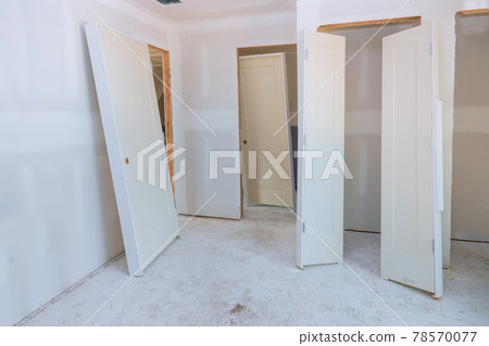A new home interior wooden stacker doors a wait installation A new home interior wooden stacker doors a wait installation 78570077