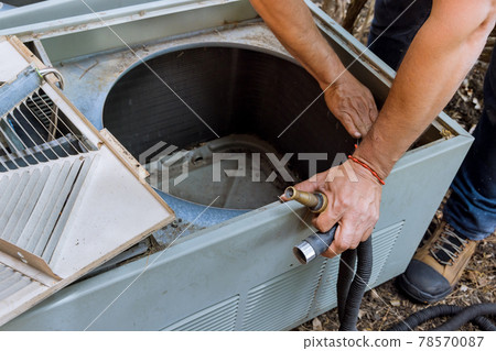 Professional man is fixing the air conditioner Professional man is fixing the air conditioner 78570087