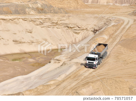 Truck with tipper semi trailer transported sand from the quarry.  78571057