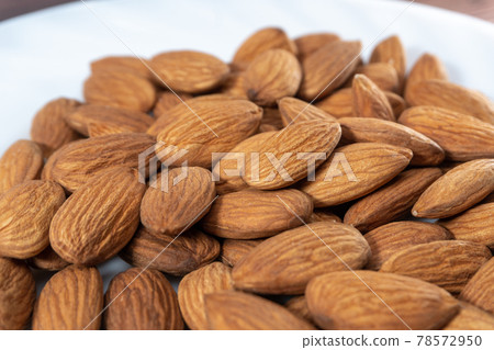 Almonds or Prunus dulcis with selective focus Almonds or Prunus dulcis with selective focus 78572950