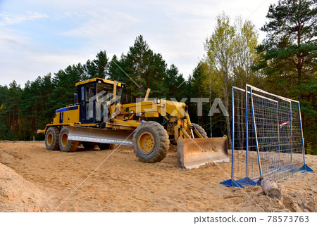 Motor Grader on road construction in forest area. Motor Grader on road construction in forest area. 78573763