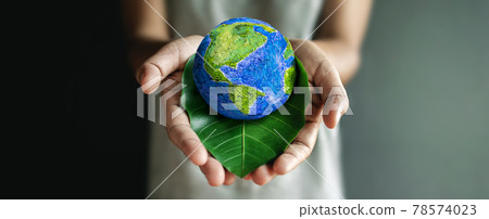 World Earth Day Concept. Green Energy, Renewable and Sustainable Resources. Environmental and Ecology Care. Hand Embracing Green Leaf and Handmade Globe 78574023