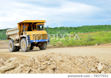 Mining truck and excavators working in the limestone open-pit.  78577052