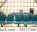 social distancing seats at airport's gate 78577366