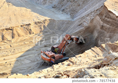 Excavator with large bucket in working in a opencast quarry. 78577438
