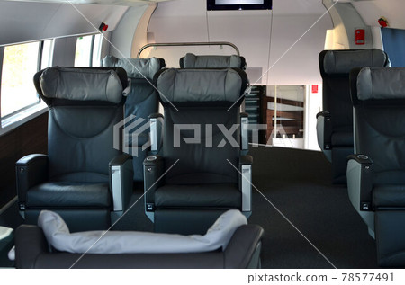 Seats in the cabin of the 1st business class carriage of a passenger high speed train. Seats in the cabin of the 1st business class carriage of a passenger high speed train. 78577491