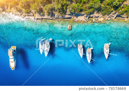 Aerial view of beautiful yachts, boats on the sea bay at sunset Aerial view of beautiful yachts, boats on the sea bay at sunset 78578669