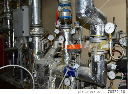 Heating system in boiler room at home. Round mechanical pressure gauge for measuring pressure Heating system in boiler room at home. Round mechanical pressure gauge for measuring pressure 78579438