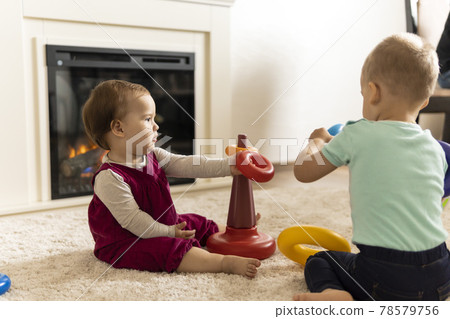 family, friends, friendship, childhood, development, skills, motility games - little authentic children toddler kids puts rings on pyramid playing together with toy sit on floor indoors at cozy home family, friends, friendship, childhood, development, skills, motility games - little authentic children toddler kids puts rings on pyramid playing together with toy sit on floor indoors at cozy home 78579756